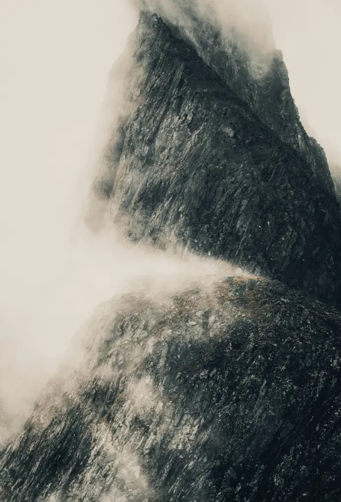 Waves breaking against a dark coastal cliff